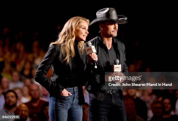 In this handout photo provided by Hand in Hand, Faith Hill and Tim McGraw speak onstage during Hand in Hand: A Benefit for Hurricane Relief at the...