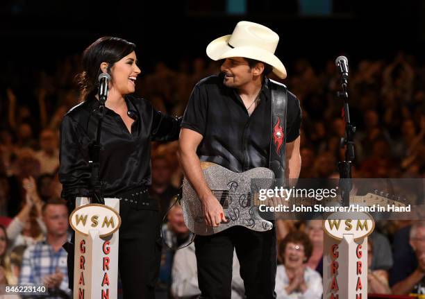 In this handout photo provided by Hand in Hand, Demi Lovato and Brad Paisley perform onstage during Hand in Hand: A Benefit for Hurricane Relief at...