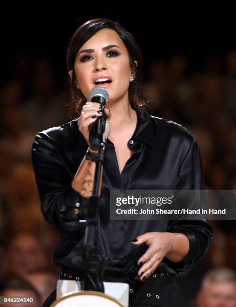 In this handout photo provided by Hand in Hand, Demi Lovato performs onstage during Hand in Hand: A Benefit for Hurricane Relief at the Grand Ole...