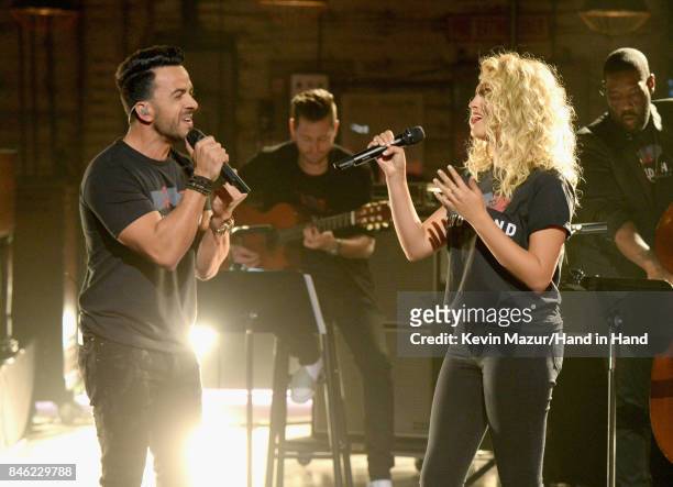 In this handout photo provided by Hand in Hand, Luis Fonsi and Tori Kelly perform during Hand in Hand: A Benefit for Hurricane Relief at Universal...