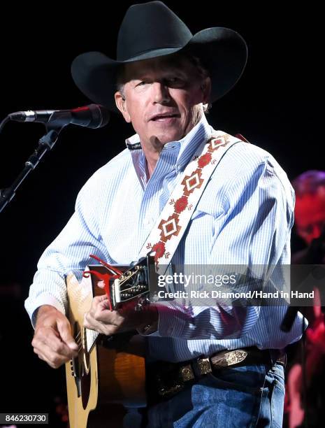 In this handout photo provided by Hand in Hand, George Strait performs onstage during George Strait's Hand in Hand Texas benefit concert; Strait and...