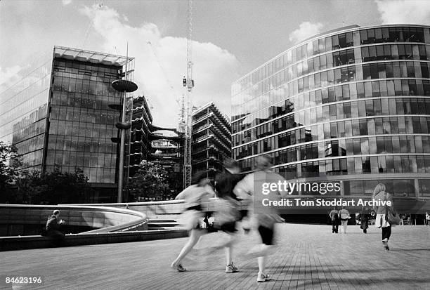 Lunchtime runners pass through More London, a new development on the River Thames opposite the Tower of London. During the last 15 years of financial...