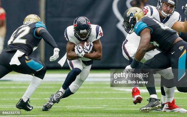 Tyler Ervin of the Houston Texans returns a punt as Breno Giacomini prepares to block Myles Jack of the Jacksonville Jaguars and Barry Church at NRG...