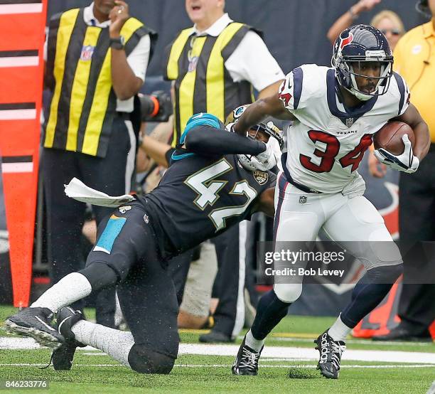 Tyler Ervin of the Houston Texans breaks the tackle attempt by Barry Church of the Jacksonville Jaguars at NRG Stadium on September 10, 2017 in...