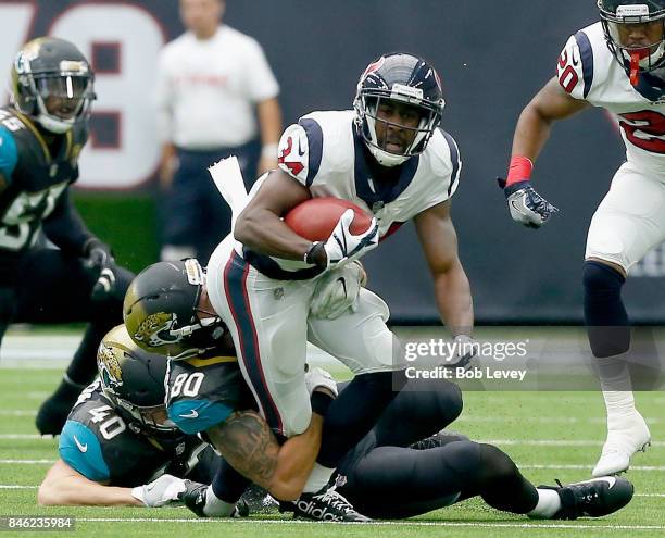 Tyler Ervin of the Houston Texans returns a punt as Tommy Bohanon of the Jacksonville Jaguars and James O'Shaughnessy attempt to tackle at NRG...