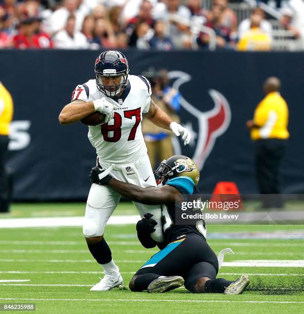 Fiedorowicz of the Houston Texans is tackled by Tashaun Gipson of the Jacksonville Jaguars after a reception at NRG Stadium on September 10, 2017 in...