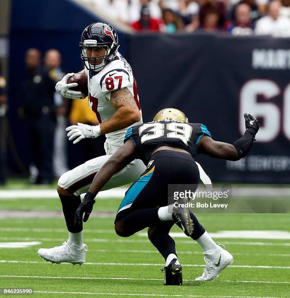 Fiedorowicz of the Houston Texans is tackled by Tashaun Gipson of the Jacksonville Jaguars after a reception at NRG Stadium on September 10, 2017 in...