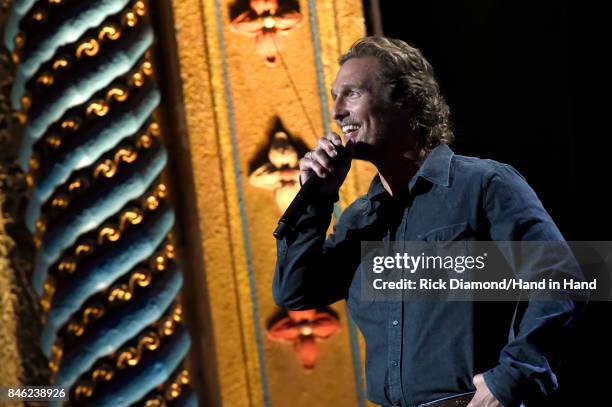 In this handout photo provided by Hand in Hand, Matthew McConaughey speaks onstage during George Strait's Hand in Hand Texas benefit concert; Strait...