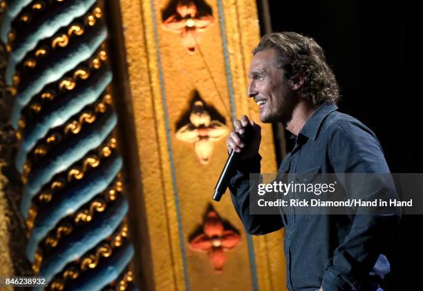 In this handout photo provided by Hand in Hand, Matthew McConaughey speaks onstage during George Strait's Hand in Hand Texas benefit concert; Strait...