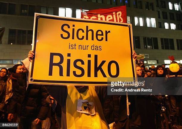 Demonstrator holds up a poster that reads 'Safe is only the risk' during a demonstration against nuclear power on February 4, 2009 in Berlin,...