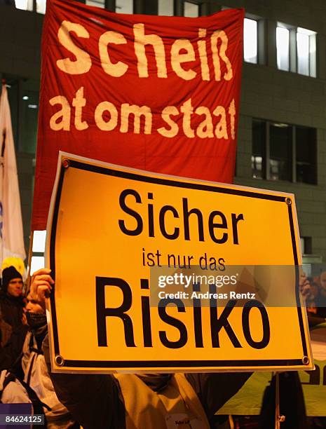 Demonstrator holds up a poster that reads 'Safe is only the risk' during a demonstration against nuclear power on February 4, 2009 in Berlin,...