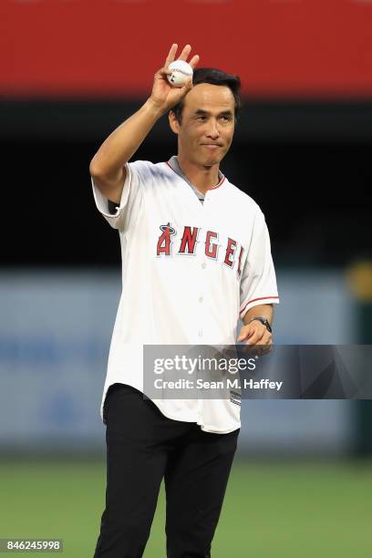 Retired pitcher Shigetoshi Hasegawa of Japan throws out the ceremonial first pitch prior to a game between the Los Angeles Angels of Anaheim and the...