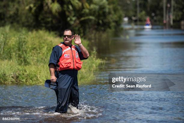 Member of the U.S. Coast Guard gestures to a colleague during rescue operations in flood waters caused by Hurricane Irma September 12, 2017 in...