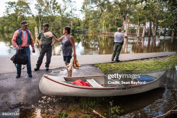 Residents talk with law enforcement after flood waters caused by Hurricane Irma inundated their neighborhood September 12, 2017 in Middleburg,...