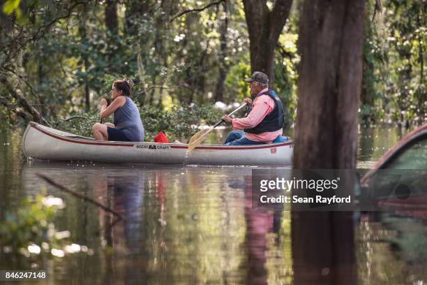 Couple uses a canoe to navigate flood waters caused by Hurricane Irma September 12, 2017 in Middleburg, Florida, United States. The storm brought...