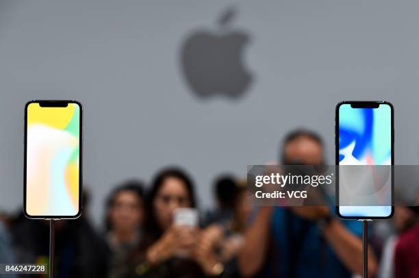 Attendees take photos of iPhone X during the Apple launch event on September 12, 2017 in Cupertino,California. Apple Inc. Unveiled its new iPhone 8,...