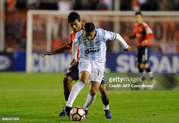 Argentina's Atletico Tucuman midfielder Rodrigo Aliendro vies for the ball with Argentina's Independiente midfielder Walter Erviti during the Copa...