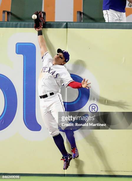 Shin-Soo Choo of the Texas Rangers jumps for the double hit by Robinson Cano of the Seattle Mariners in the sixth inning at Globe Life Park in...