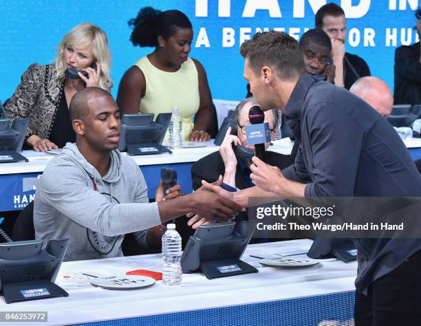 In this handout photo provided by Hand in Hand, Chris Paul and Ryan Seacrest caption at ABC News' Good Morning America Times Square Studio on...