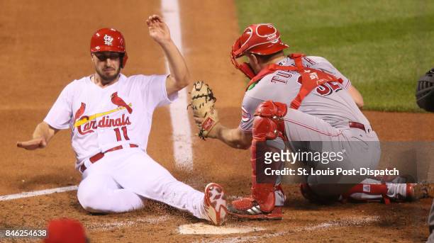 The St. Louis Cardinals' Paul DeJong scores on a two-run double by Jose Martinez past Cincinnati Reds catcher Stuart Turner in the fourth inning on...