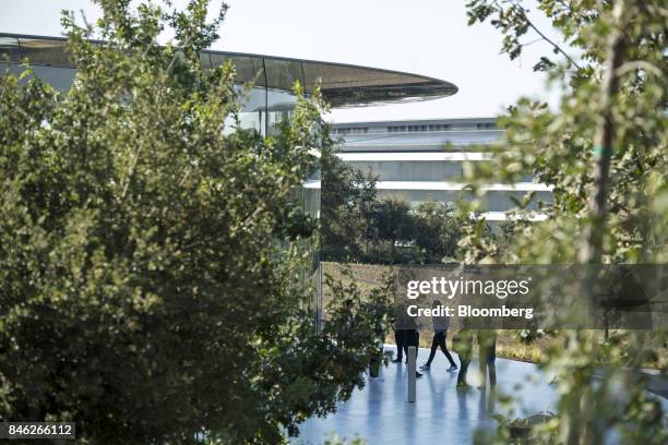 Attendees stand outside the Steve Jobs Theater on the Apple Inc. Campus after an event in Cupertino, California, U.S., on Tuesday, Sept. 12, 2017....