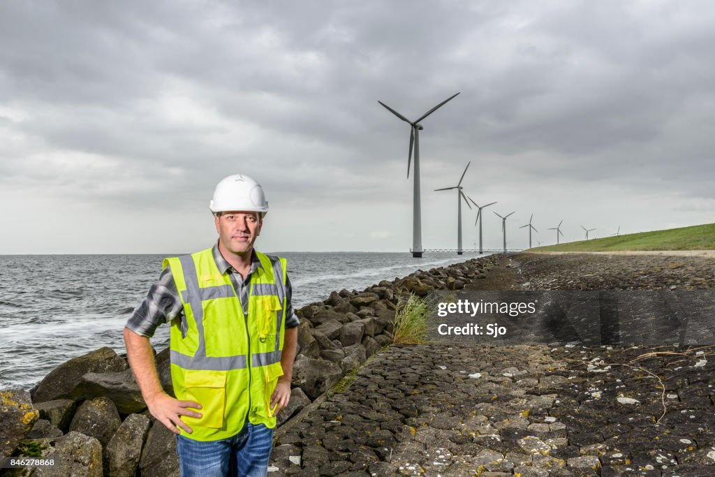 Engineer at an offshore wind turbine park during an overcast day