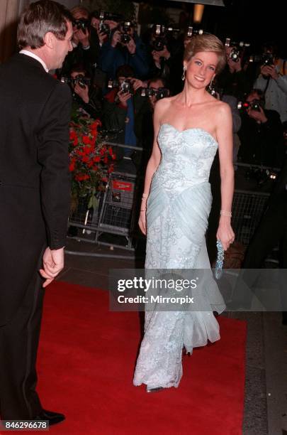 Princess Diana wearing an eggshell blue lace strapless evening dress designed by Catherine Walker, attends a Moulin Rouge performance at The Savoy...