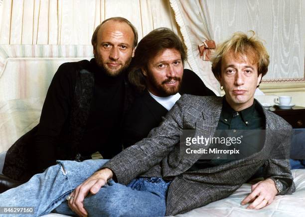 Bee Gees Pop Group brothers Maurice Gibb Barry Gibb & Robin Gibb together relax before the start of a tour, 30th March 1989.