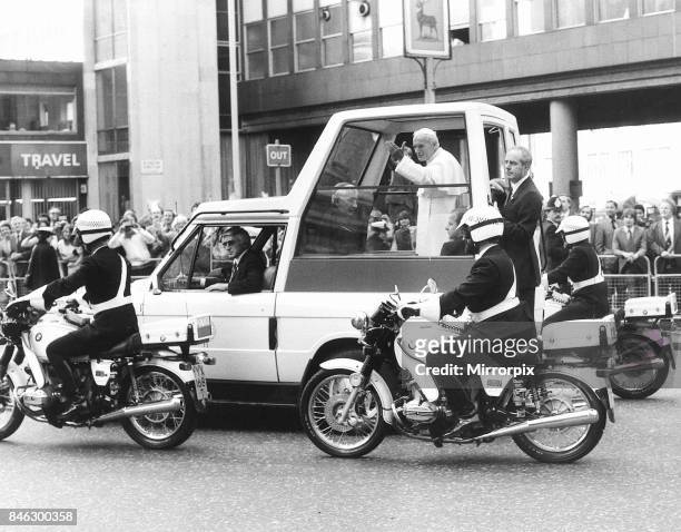Pope John Paul II Visit to Britain 1982, the Pope waves to the crowds lining his route through London from his pope mobile.