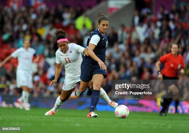 Carli Lloyd of the USA and Desiree Scott of Canada in action during the Women's Football Semi Final match between Canada and USA, on Day 10 of the...