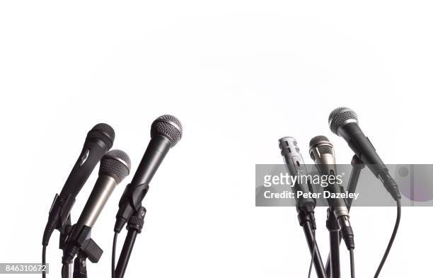 press conference microphones with white copy space - press conference stock pictures, royalty-free photos & images