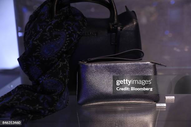 The Maserati logo sits embossed on a leather purse and handbag inside the Maserati SpA luxury pop-up store during the first media preview day of the...