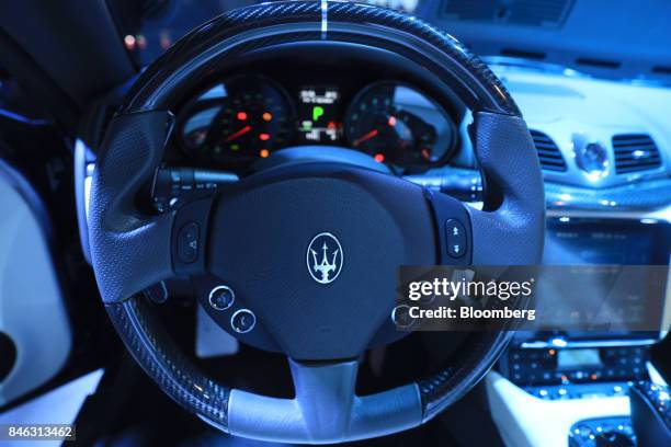 Logo sits on the steering wheel of a Maserati GranCabrio Sport luxury automobile, manufactured by Maserati SpA, a unit of Fiat Chrysler Automobiles...