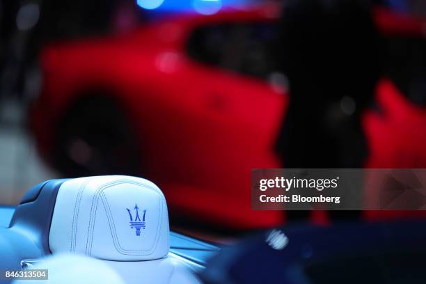 Logo sits on the white leather headrest of a Maserati GranCabrio Sport luxury automobile, manufactured by Maserati SpA, a unit of Fiat Chrysler...