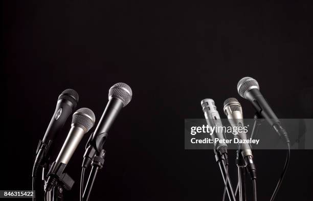 press conference microphones with black copy space - press conferences stock pictures, royalty-free photos & images