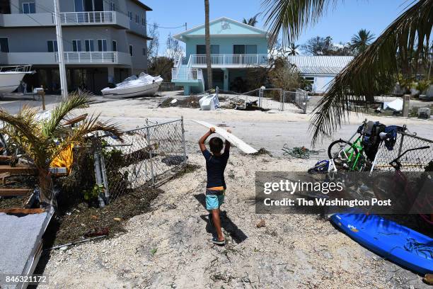 Kevin Chavez helps remove debris from his family's damaged home following Hurricane Irma in the Tavernier area located in the Florida Keys on Tuesday...