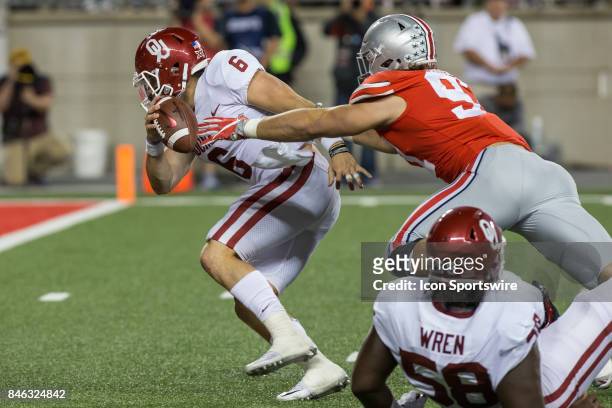 Oklahoma Sooners quarterback Baker Mayfield tries to avoid being sacked by Ohio State Buckeyes defensive lineman Nick Bosa during game action between...