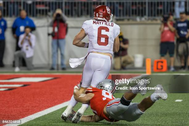 Oklahoma Sooners quarterback Baker Mayfield tries to avoid being sacked by Ohio State Buckeyes defensive lineman Nick Bosa during game action between...