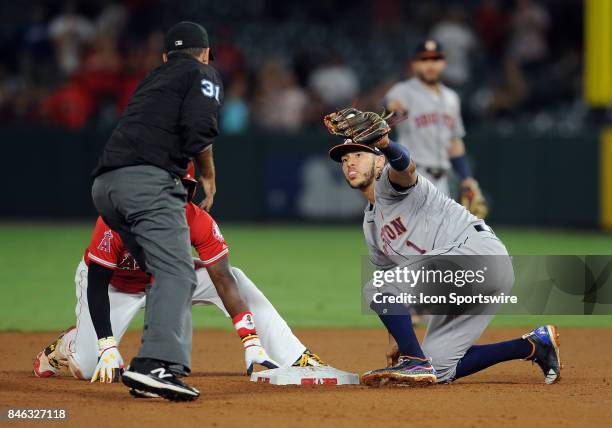 Houston Astros shortstop Carlos Correa looks up at second base umpire Pat Hoberg who calls Los Angeles Angels of Anaheim runner Brandon Phillips out...