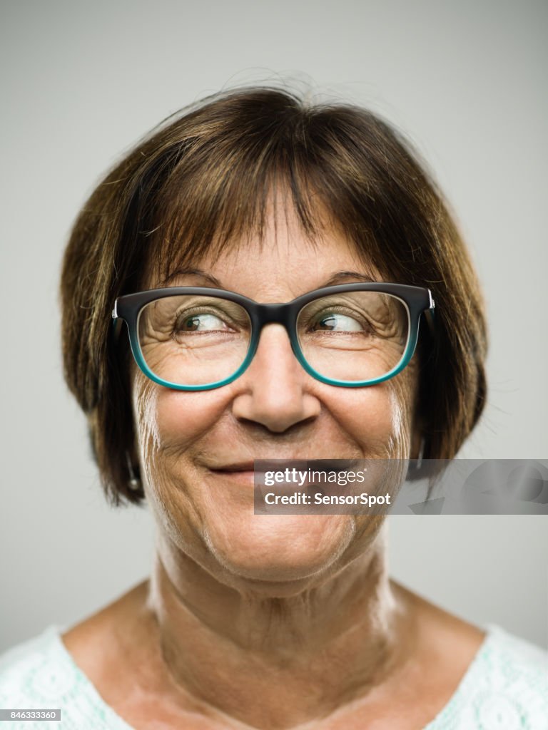 Real senior woman portrait looking away