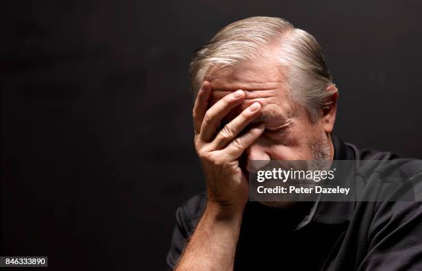 senior man with depression - touching head stock pictures, royalty-free photos & images