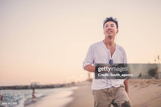 walking on the beach and enjoying music - beach music stock pictures, royalty-free photos & images