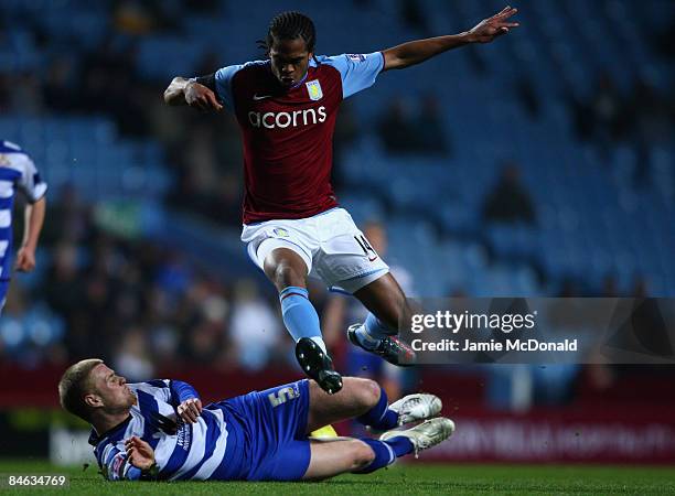 Nathan Delfouneso of Aston Villa is tackled by Matthew Mills of Doncaster Rovers during the F.A Cup sponsored by E.on 4th round replay match between...