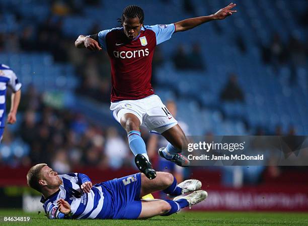 Nathan Delfouneso of Aston Villa is tackled by Matthew Mills of Doncaster Rovers during the F.A Cup sponsored by E.on 4th round replay match between...