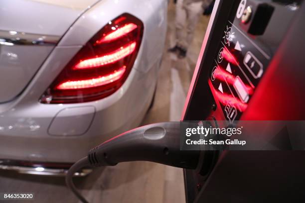 The new Mercedes-Benz S560e plug-in hybrid car stands next to a charging station at the 2017 Frankfurt Auto Show on September 13, 2017 in Frankfurt...