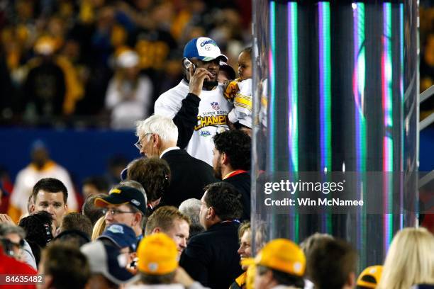 Head coach Mike Tomlin of the Pittsburgh Steelers talks on the phone to U.S. President Barack Obama after the Steelers defeated the Arizona Cardinals...