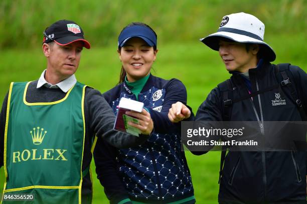 Defending Champion In Gee Chun of South Korea looks happy with her caddie and coach during the pro - am prior to the start of The Evian Championship...