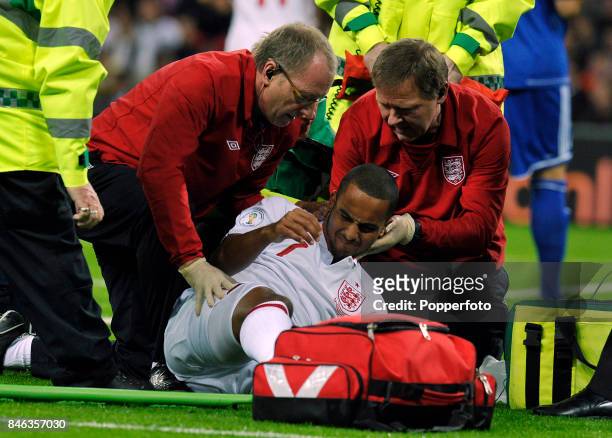 Theo Walcott of England receives treatment for injury during the FIFA 2014 World Cup qualifying match between England and San Marino at Wembley...