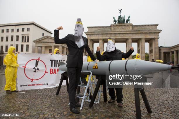 International campaign to abolish Nuclear Weapons activists wearing masks to look like US President Donald Trump and North Korean Kim Jong-Un pose...