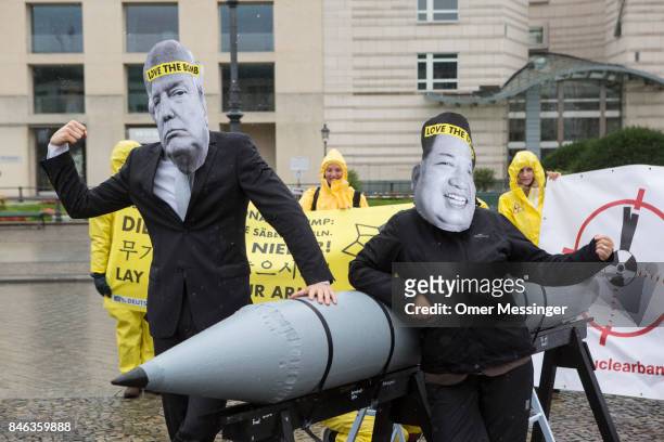 International campaign to abolish Nuclear Weapons activists wearing masks to look like US President Donald Trump and North Korean Kim Jong-Un pose...